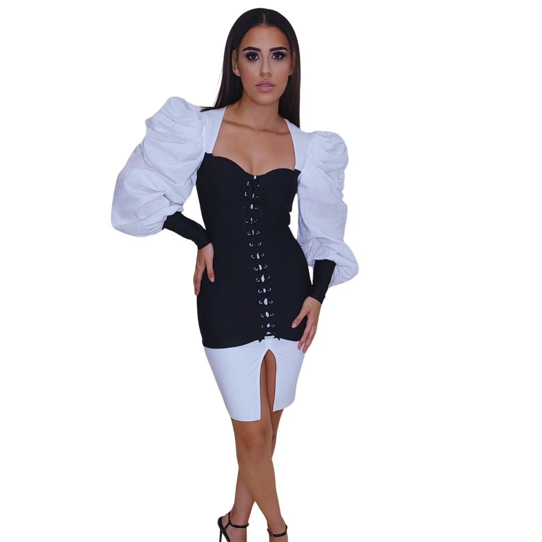 vestido corset bicolor
vestido blanco y negro
ropa elegante mujer
vestido con mangas abullonadas
vestido con abertura lateral
moda premium boutique
vestido formal chic
outfit noche sofisticado
estilo GV exclusivo
moda femenina estructurada